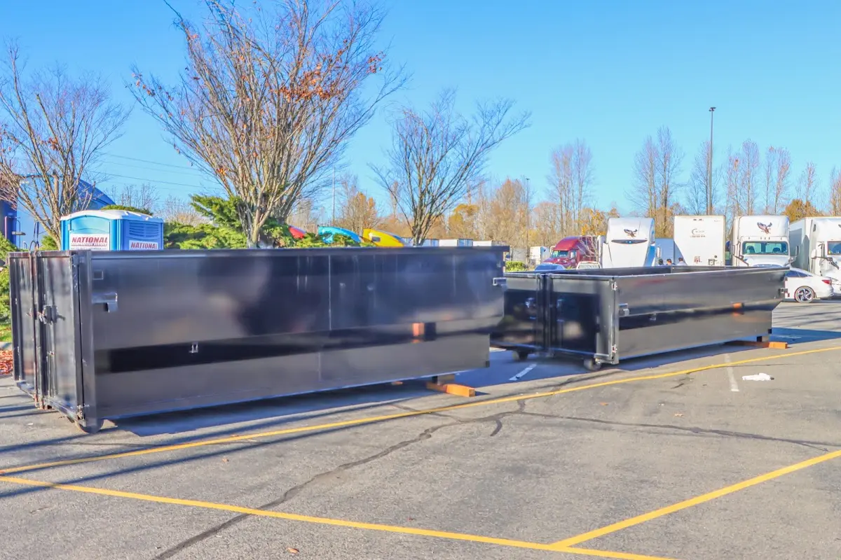 Professional dumpster rental service with roll-off container on residential driveway in Trinity